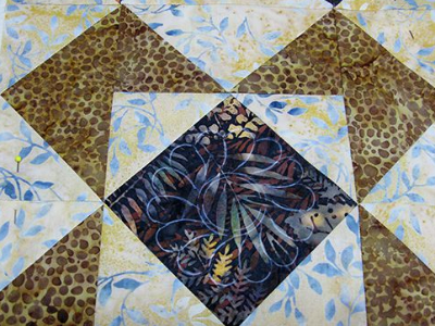 accuquilt-12-inch-die-french-roasted-batiks-feather-quilt