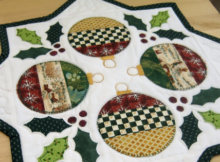 holly table topper with Christmas ornaments