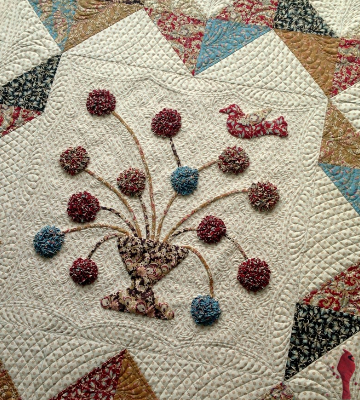 chevron-wall-quilt-with-vase-of-flowers-and-bird