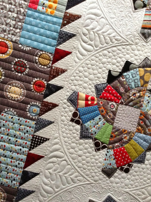 fan-quilt-with-half-square-triangle-inner-border