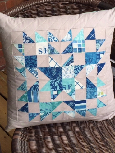 decorative pillow made with mini charm squares