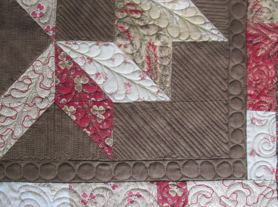 quilting feathers on a Bali Sky Carpenters Star