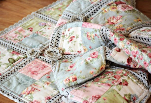 patchwork quilt with crochet roses
