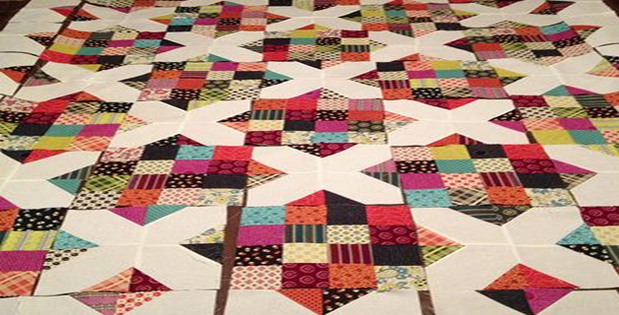 Jelly Roll Quilt With Four Patches Plus An X and O
