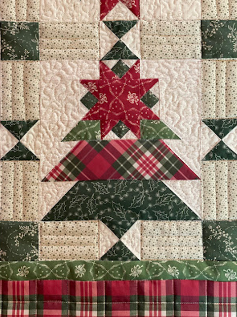 Christmas ornament star on a christmas tree quilt